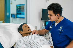 A UNC Greensboro School of Nursing student practices in a simulation lab.