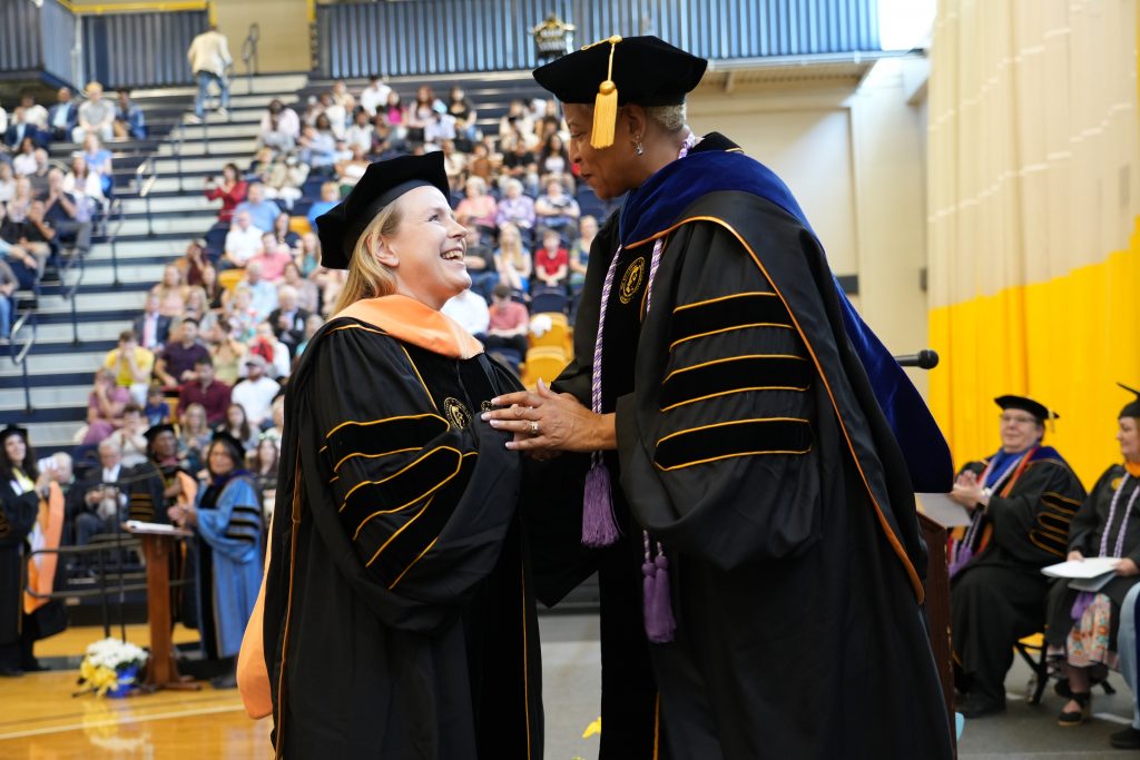 Susan Fischer smiles with UNC Greensboro School of Nursing professor Dr. Wanda Williams.