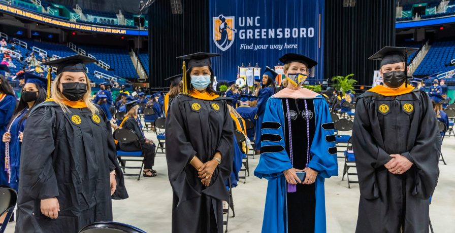 UNC Greensboro Master of Science in Nursing graduates pose at commencement..