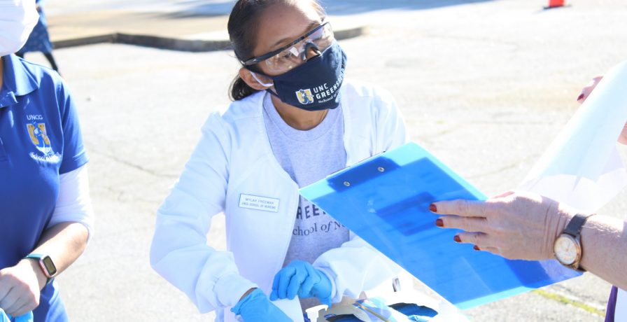 UNC Greensboro School of Nursing student works at a mobile flu clinic.