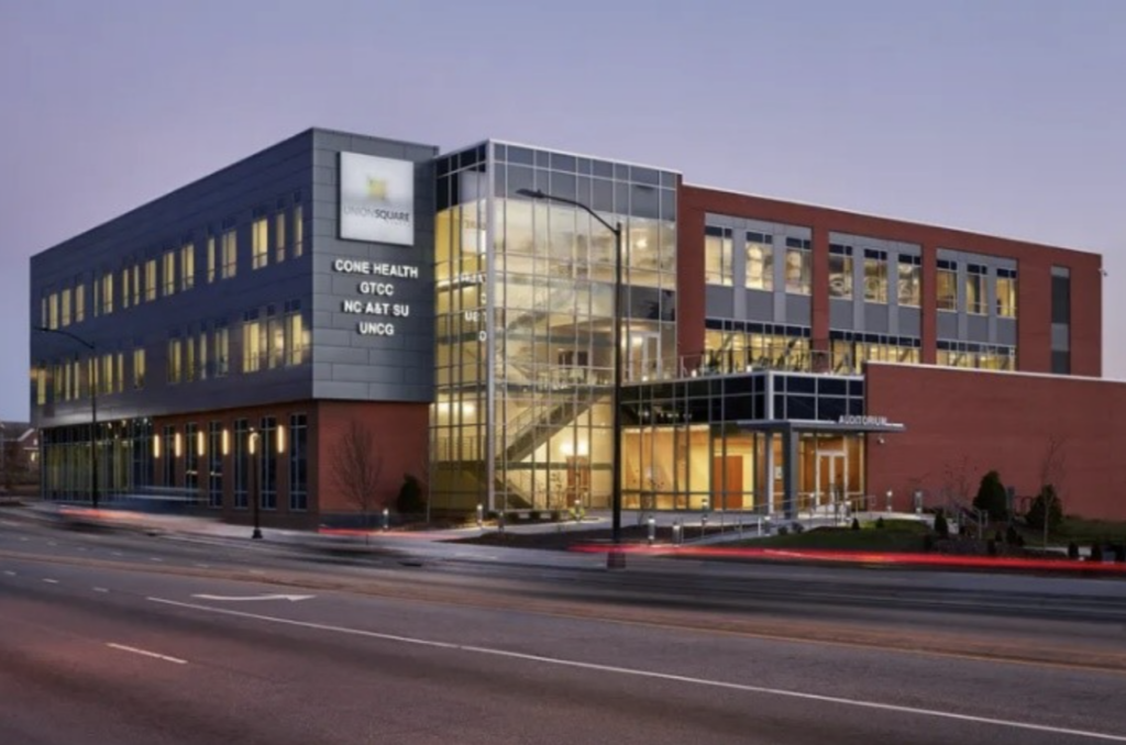 Union Square Campus (USC) building exterior at dusk.